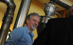 Laughing Whale Coffee owner/operator Steve Zubalik , smiles as he listens to Environment Minister Sterling Belliveau.