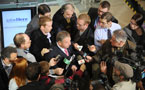 Premier Darrell Dexter is surrounded by reporters during a scrum after the jobsHere economic plan announcement.