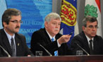 Energy Minister Charlie Parker takes a question while his Newfoundland and Labrador counterpart Shawn Skinner(left) and  P.E.I. Energy Minister Richard Brown (right) look on.