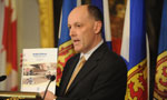 Finance Minister Graham Steele holds up a copy of the budget address.