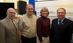 Premier Darrell Dexter and Emergency Management Minister Ross Landry stand with Ron and Nancy Arenburg, who helped bring the tracking system to Nova Scotia.