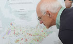 A man gets a closer look at map showing potential candidates for protected area status.