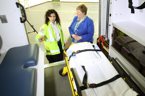 Paramedic Nancy Habib points out some of the details of the ambulance to Health and Wellness Minister Maureen MacDonald.
