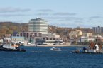 A tidal turbine is towed in the Halifax Harbour in front of the Dartmouth shoreline.