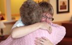 Cheryl Myers, site manager of Debert Court, receives a hug from resident Muriel Cooke in one of the common areas.