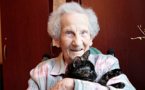 Virginia, a resident of Debert Court, poses for a picture with one of the house cats, Mabel.